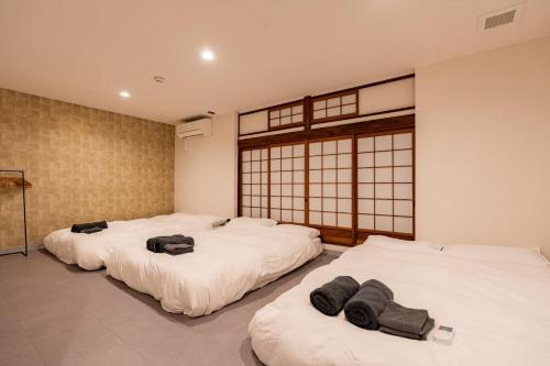 Giường trong phòng chung tại 春風荘 imazato