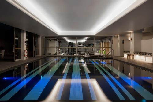 a large swimming pool in a building with blue lanes at Ovolo Sydney Woolloomooloo, a Wyndham Hotel in Sydney