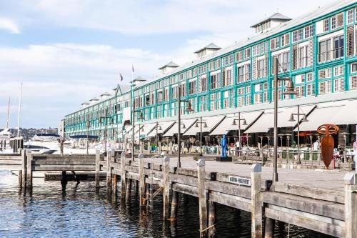 a building with a dock in front of a marina at Ovolo Sydney Woolloomooloo, a Wyndham Hotel in Sydney