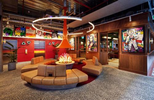 a living room with a fire in the middle at Ovolo Melbourne South Yarra, a Wyndham Hotel in Melbourne