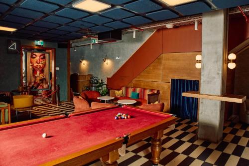 a billiard room with a red pool table in it at Ovolo Melbourne South Yarra, a Wyndham Hotel in Melbourne