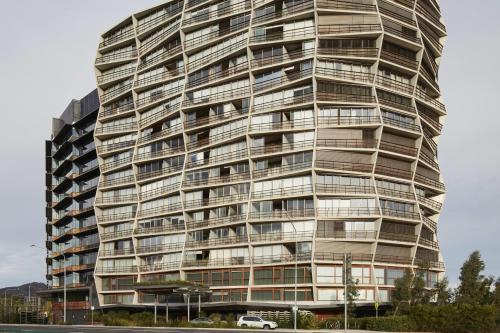 a tall building with a car parked in front of it at Ovolo Canberra, a Wyndham Hotel in Canberra