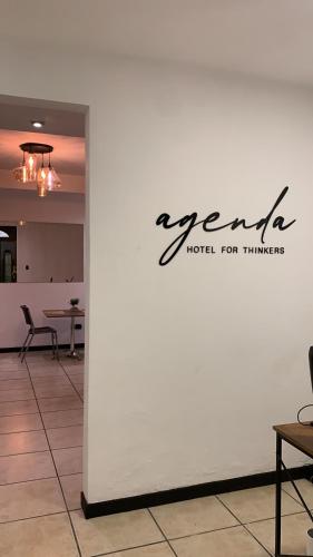 a white wall with a sign on it at Agenda Hotel in San Salvador