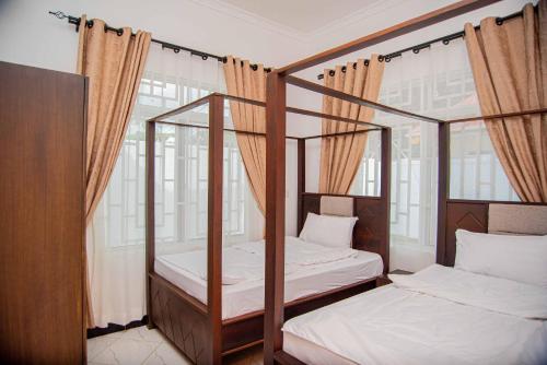 2 letti a castello in una camera con finestre di BNJ Royal Palace a Dar es Salaam