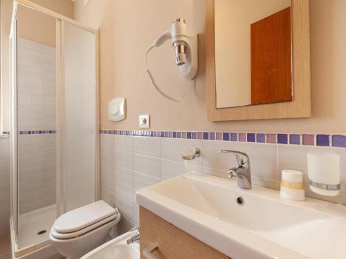 a bathroom with a sink and a toilet and a mirror at Alba Adriatica apartments charm in Alba Adriatica