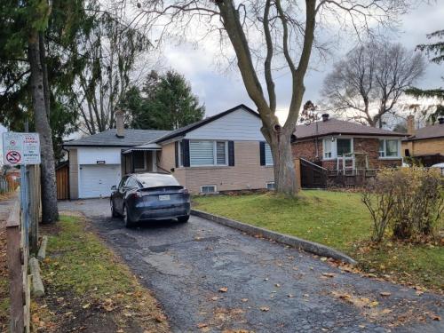 a car parked in front of a house at Newly Renovated 3BR Upper Unit - Bright & Quiet in Richmond Hill