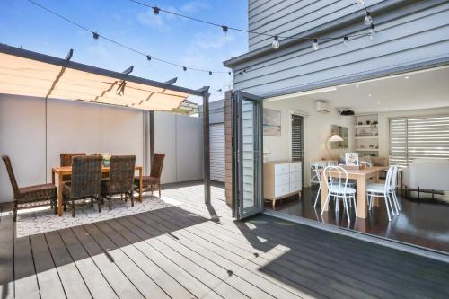 a patio with a table and chairs on a deck at Home Away From Home - Maribyrnong Boutique Townhouse in Maribyrnong