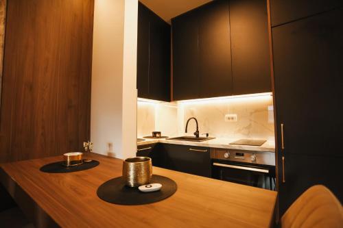 a kitchen with a wooden counter top with a sink at Grand Residence Zlatibor in Zlatibor