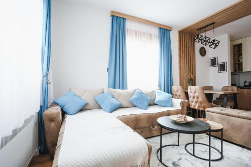 a living room with a couch and a table at Grand Residence Zlatibor in Zlatibor