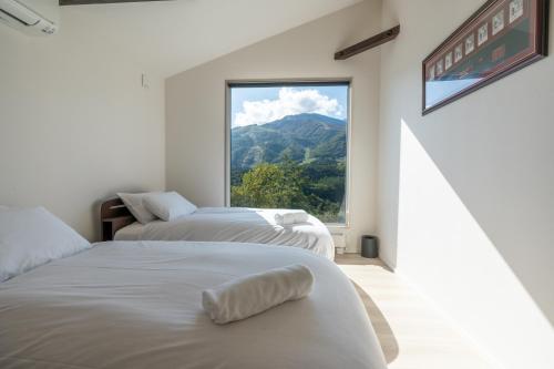 Postel nebo postele na pokoji v ubytování KIBEJE Hakuba by JAMSZ ROYALE