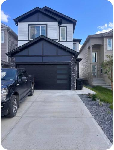 a car parked in front of a black garage at Private room in Basement suite in Edmonton