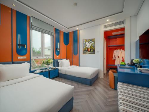 a hotel room with two beds and a bathroom at Minerva Church Hotel in Hanoi