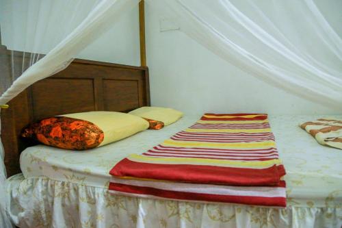 Ліжко або ліжка в номері Sagopearl Guest