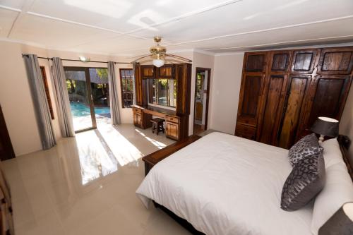 a bedroom with a bed and a large window at The Sweetest Spot in St Lucia