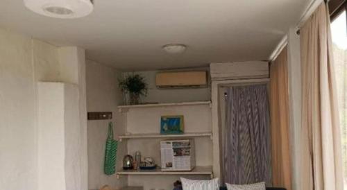 a room with a living room with a window and a couch at Brassiere Beach Hotel in Baanphakrimlay 