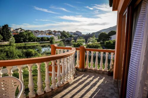 a balcony with a view of a river and houses at Apartman Selena in Trebinje