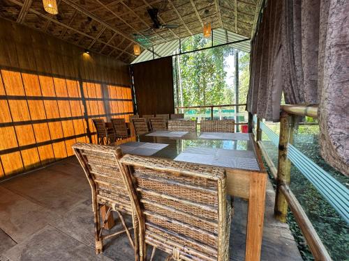 a dining room with a table and chairs at Kaziranga Tea Nest Homestay in Kāziranga