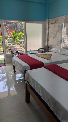 Postel nebo postele na pokoji v ubytování Nandish Guest House