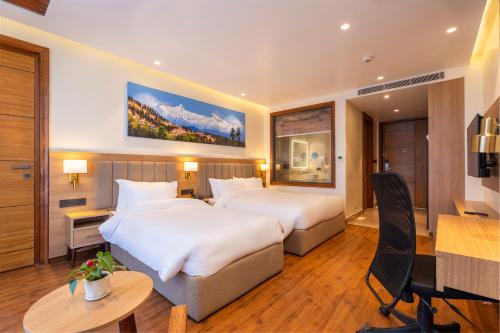 En eller flere senge i et værelse på Mankamana Hillcrest Resort