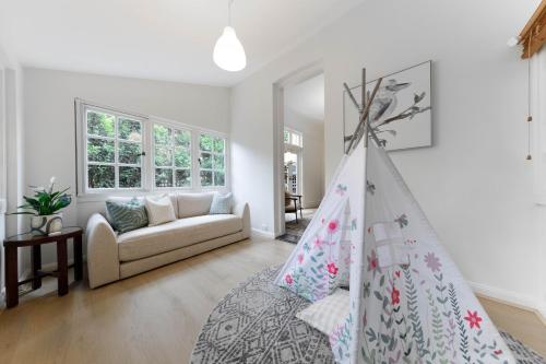 a living room with a couch and a bed at Spacious 3BR Family Home at Central Chatswood in Sydney