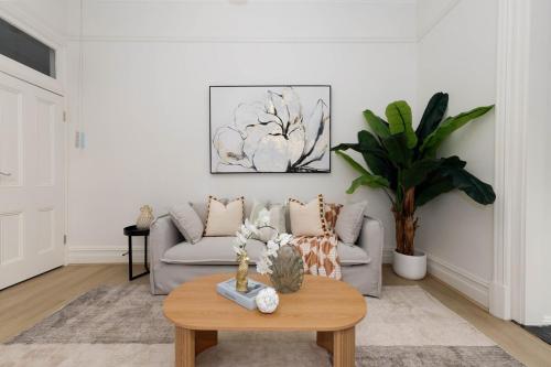 a living room with a couch and a coffee table at Spacious 3BR Family Home at Central Chatswood in Sydney