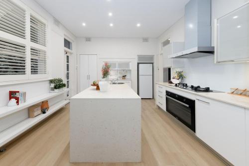 a kitchen with white counters and a white counter top at Spacious 3BR Family Home at Central Chatswood in Sydney