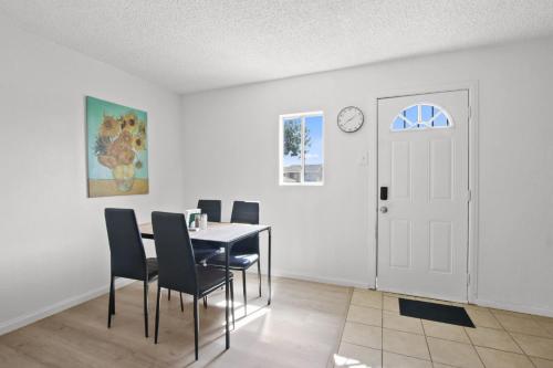 a dining room with a table and chairs and a clock at Charming House Free RV Parking in Upland