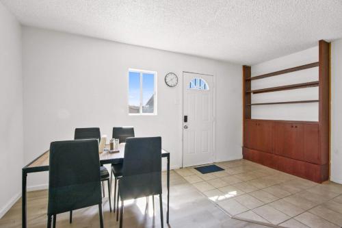 a dining room with a table and chairs and a door at Charming House Free RV Parking in Upland