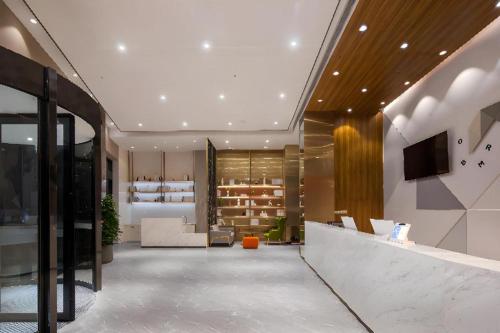 a lobby of a store with a tv on the wall at Borrman Hotel Guilin North Railway Station Zhonghao International in Lingchuan