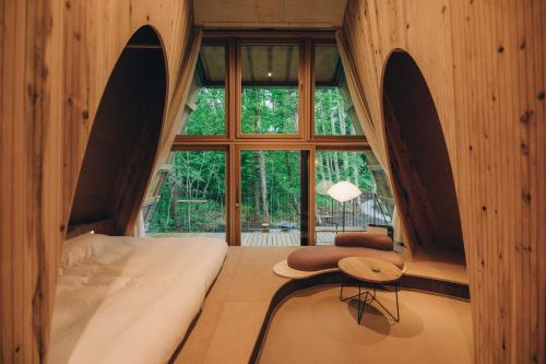 a bedroom with a bed with a large window at SANU 2nd Home 河口湖1st in Fujikawaguchiko