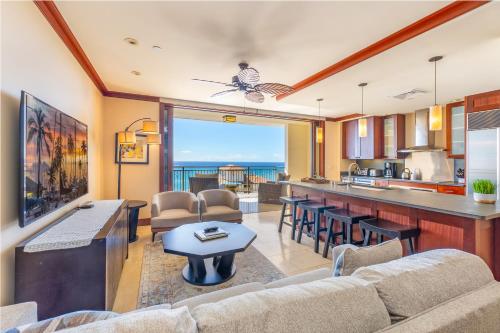 a kitchen and living room with a view of the ocean at TOP Floor Penthouse with Panoramic View - Ocean Tower at Ko Olina Beach Villas Resort in Kapolei