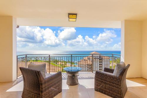 a balcony with chairs and a view of the ocean at TOP Floor Penthouse with Panoramic View - Ocean Tower at Ko Olina Beach Villas Resort in Kapolei