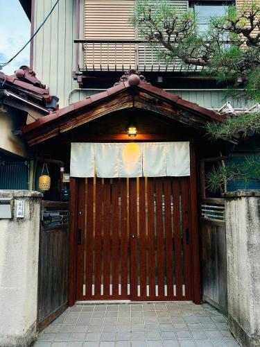 a brown garage door with a white curtain on it at Zen House - Tajimi in Tajimi