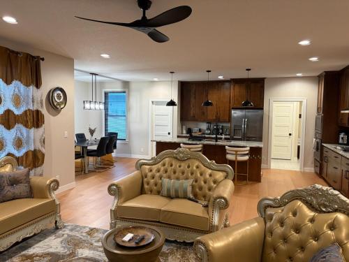 a living room with two couches and a kitchen at Luxurious Sweet Escape stunning custom Home! in Rochester
