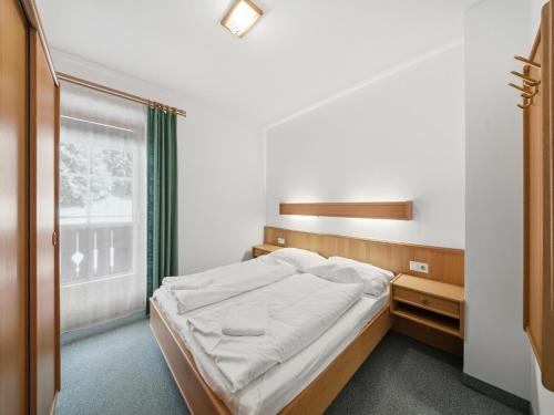 a bedroom with a bed and a window at Apartment in a quiet location in Mittersill in Mittersill