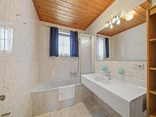 a bathroom with a tub and a sink at Apartment in Mittersill with mountain view in Mittersill