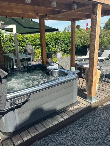 a hot tub sitting under a gazebo at Vakantiehuis aan het water in Vinkeveen