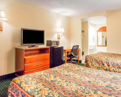 a hotel room with two beds and a flat screen tv at Rodeway Inn Mount Laurel Hwy 73 in Ramblewood