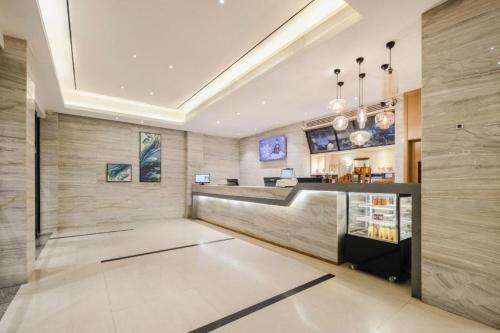 a lobby with a bar in a building at City Comfort Inn Wuzhou Wangcheng Square in Wuzhou