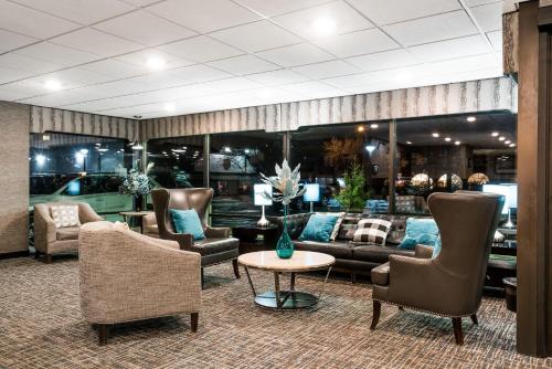 a lobby with couches and chairs and a table at Days Hotel by Wyndham University Ave SE in Minneapolis