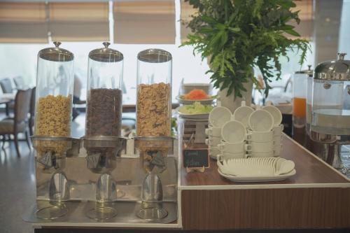 a buffet line with bowls and plates of food at Cross Vibe Bangkok Srinakarin in Bangkok