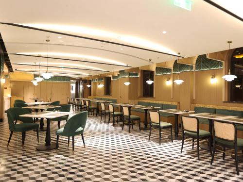 a restaurant with tables and chairs in a room at Habo Hotel Shanghai, a member of Design Hotels in Shanghai