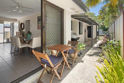 a patio with a table and chairs on a house at Golden Beach Bungalow - 500m to the beach in Golden Beach