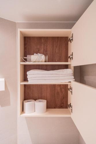 a bathroom with white towels in a closet at Harujae Myeongdong in Seoul