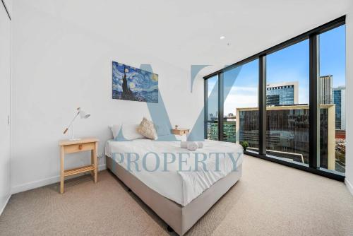 a bedroom with a bed and a large window at Metro Nest Light-Filled 1BR in CBD in Perth