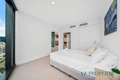 a bedroom with a bed and a large window at Metro Nest Light-Filled 1BR in CBD in Perth