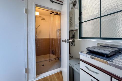 a bathroom with a shower and a toilet and a sink at epilogue hotel 302 in Fukuoka