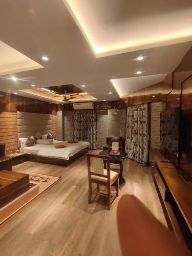a bedroom with a bed and a desk with a desk at Krishti Resorts in Tajpur