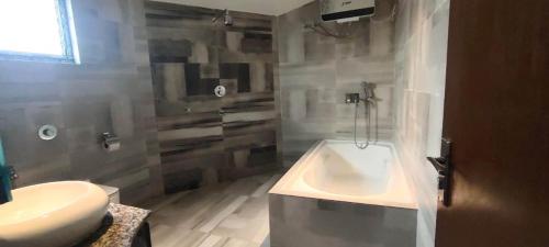 a bathroom with a shower and a tub and a sink at Krishti Resorts in Tajpur