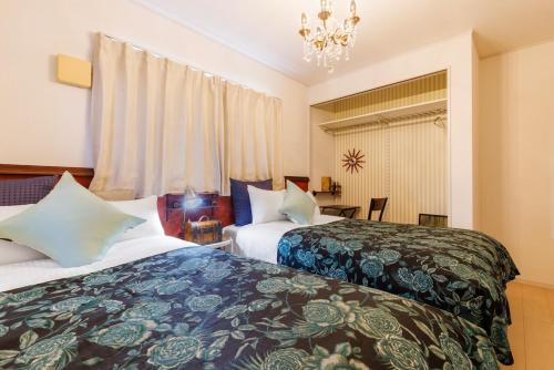 Postel nebo postele na pokoji v ubytování 本部町 最大12名宿泊可 無料駐車場2台付き 家族 グループに最適 Terrace Motobu